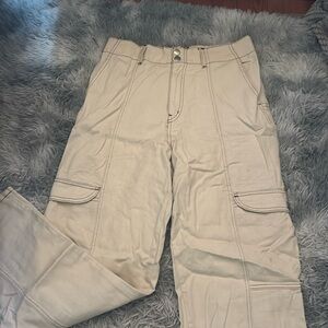 cream colored cargo pants with brown stitching
